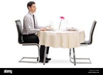 young-man-sitting-at-a-restaurant-table-and-waiting-for-his-date-isolated-G23D07.jpg