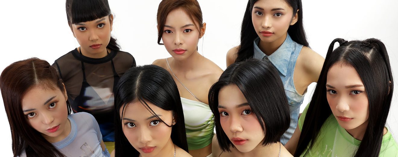 the official announcement image for YGIG. It shows the 7 girls standing in a cluster underneath the group logo.